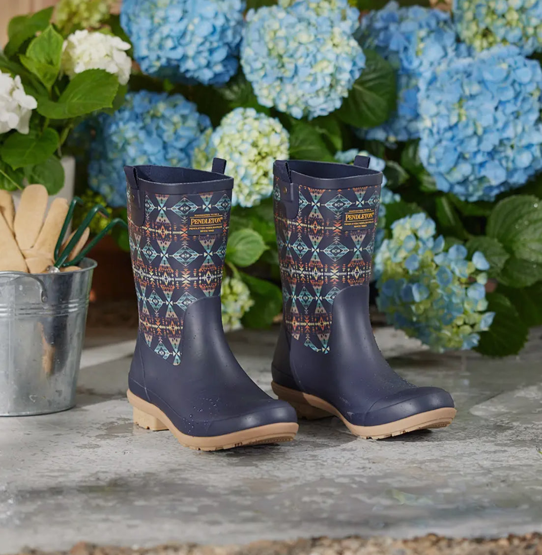 A pair of navy blue Pendleton women's waterproof rain boots with an azte pattern.