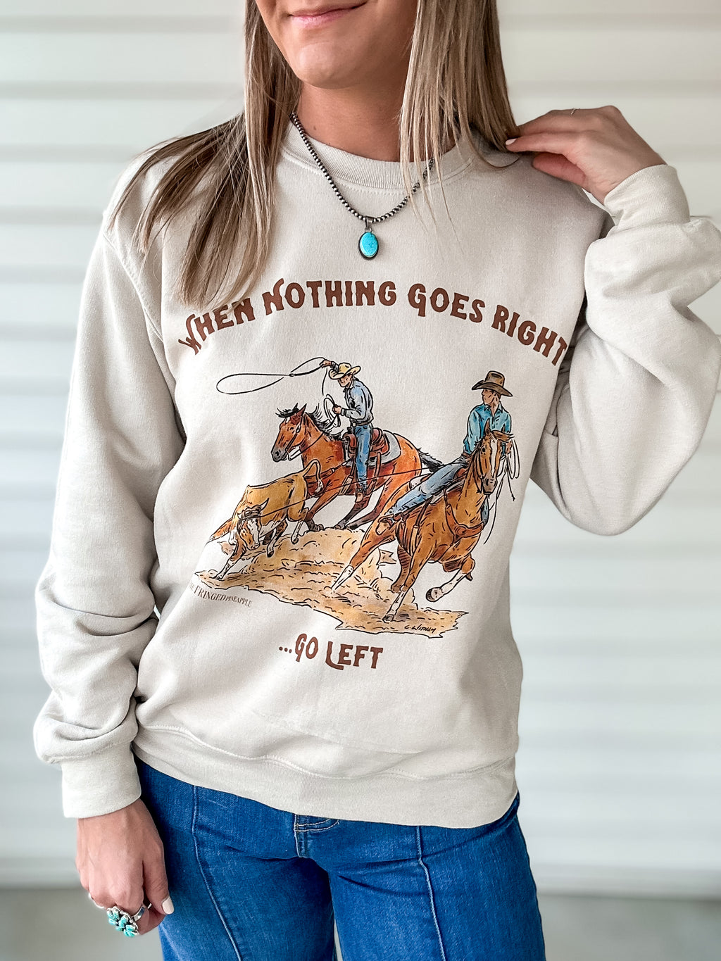 Beige sweatshirt with a team roping graphic
