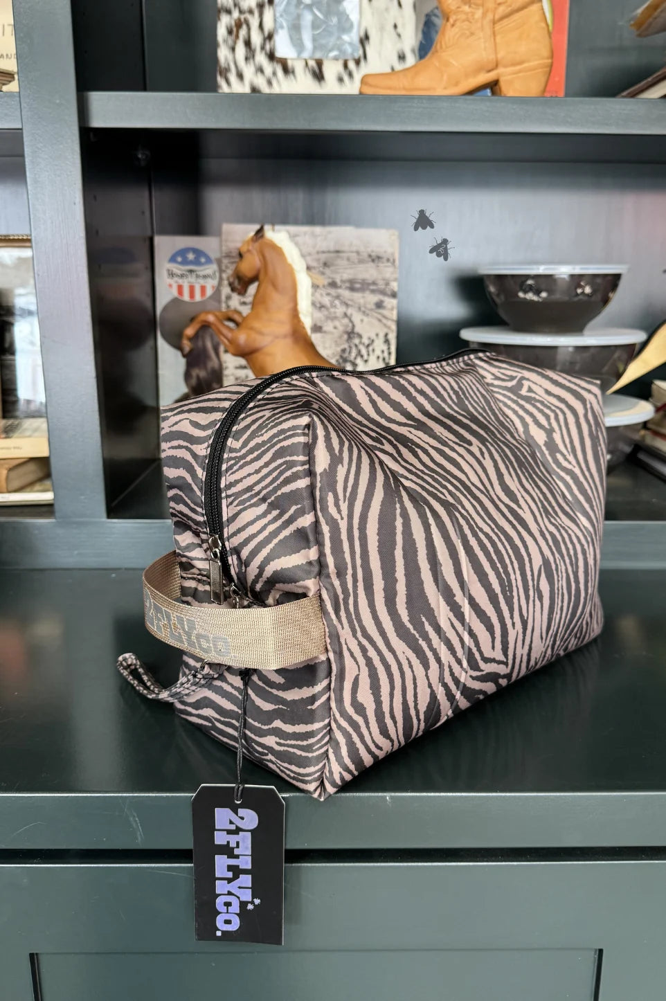 A zebra-print toiletry bag wirh zipper
