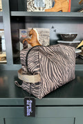 A zebra-print toiletry bag wirh zipper