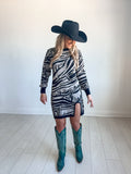 Sweater dress with round slit and black and white zebra pattern with western graphics throughout 