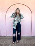 Black high-rise cropped flare jeans with distressed details and a frayed hem.