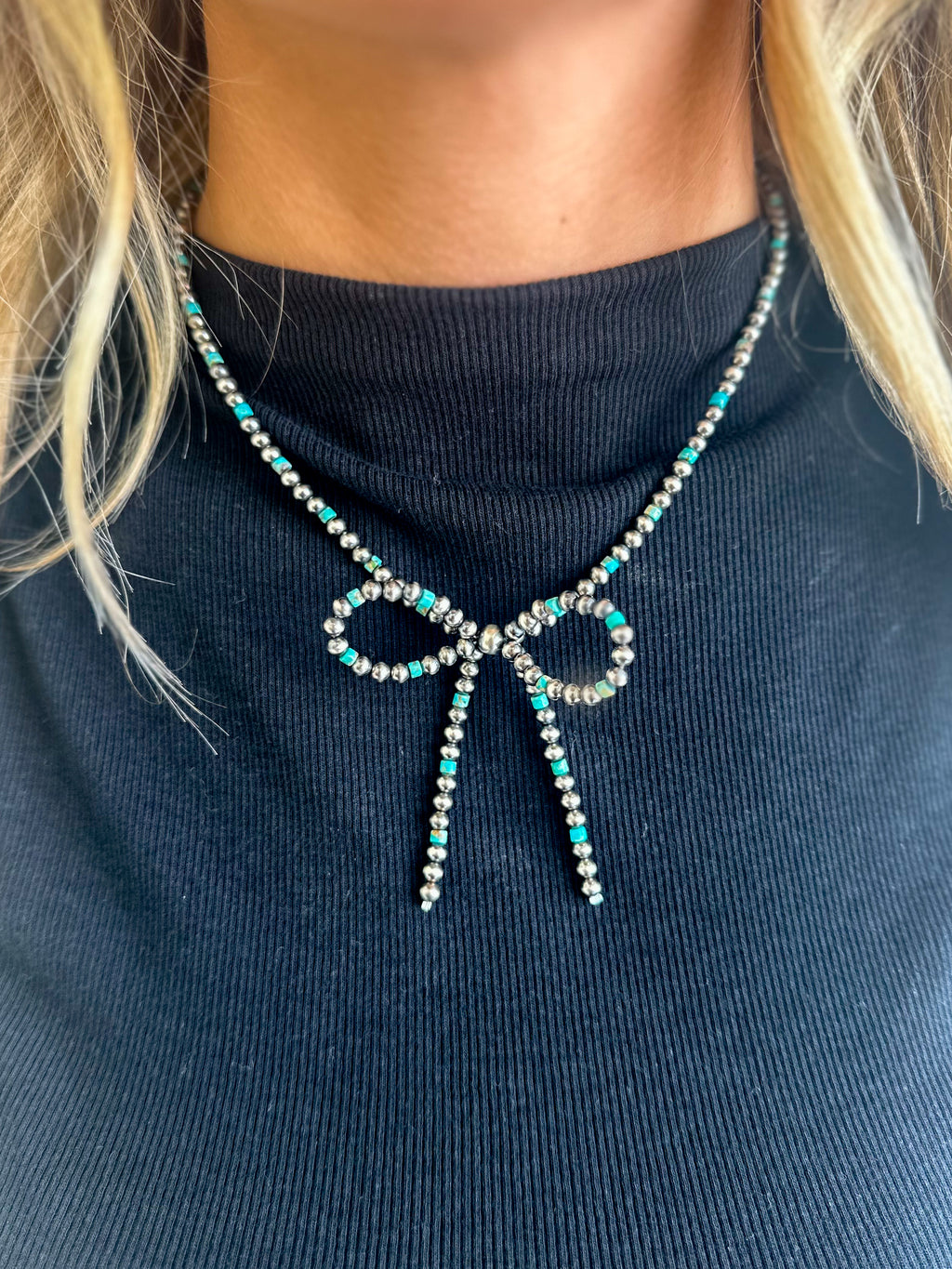Turquoise and sterling silver bow necklace.