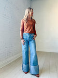 High waisted light wash wide leg jeans with a wide cuffed inseam and square pockets