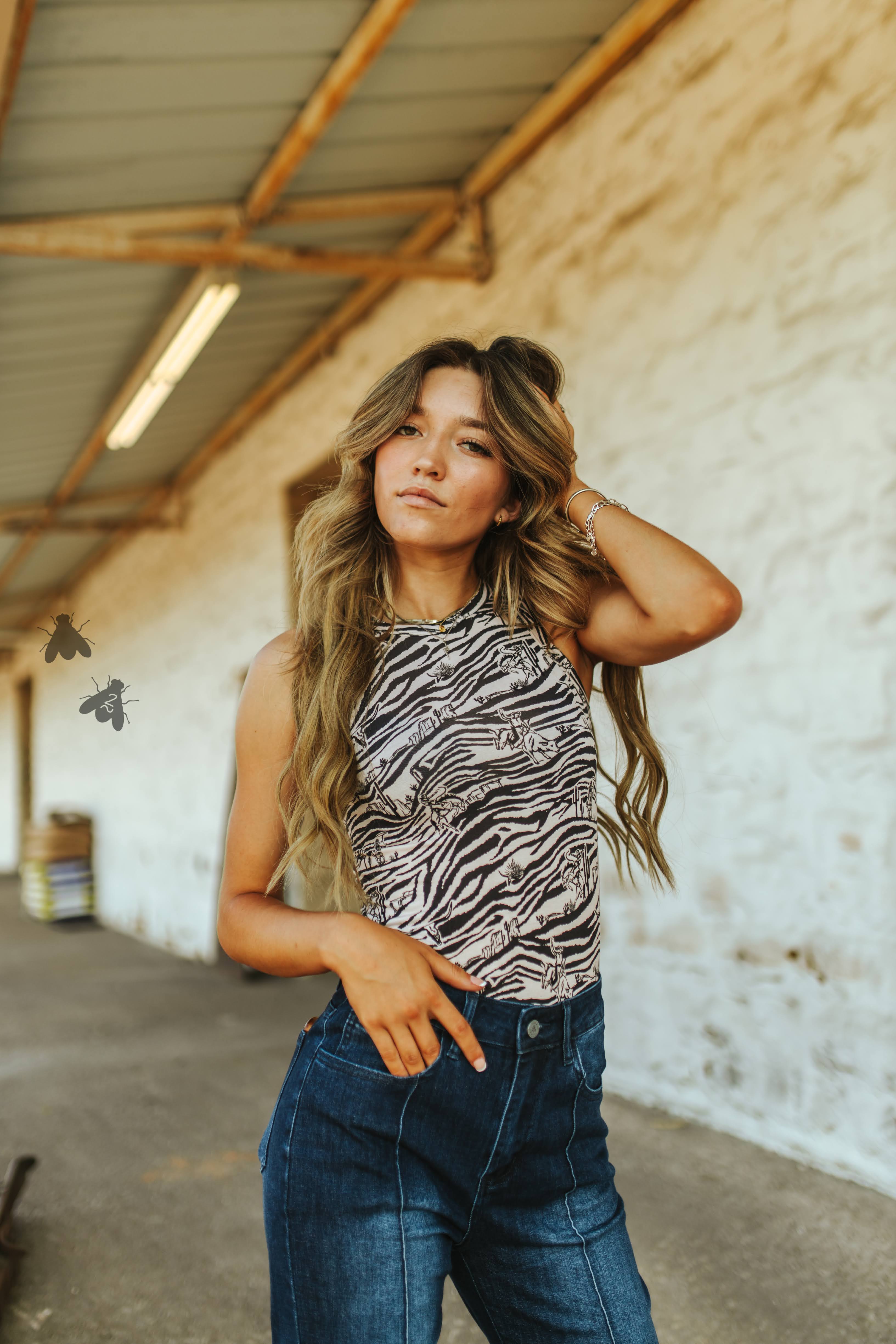 Black and white zebra print tank top with western graphics mixed throughout.