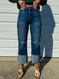 High rise dark wash straight leg jeans with distressing at the knee.