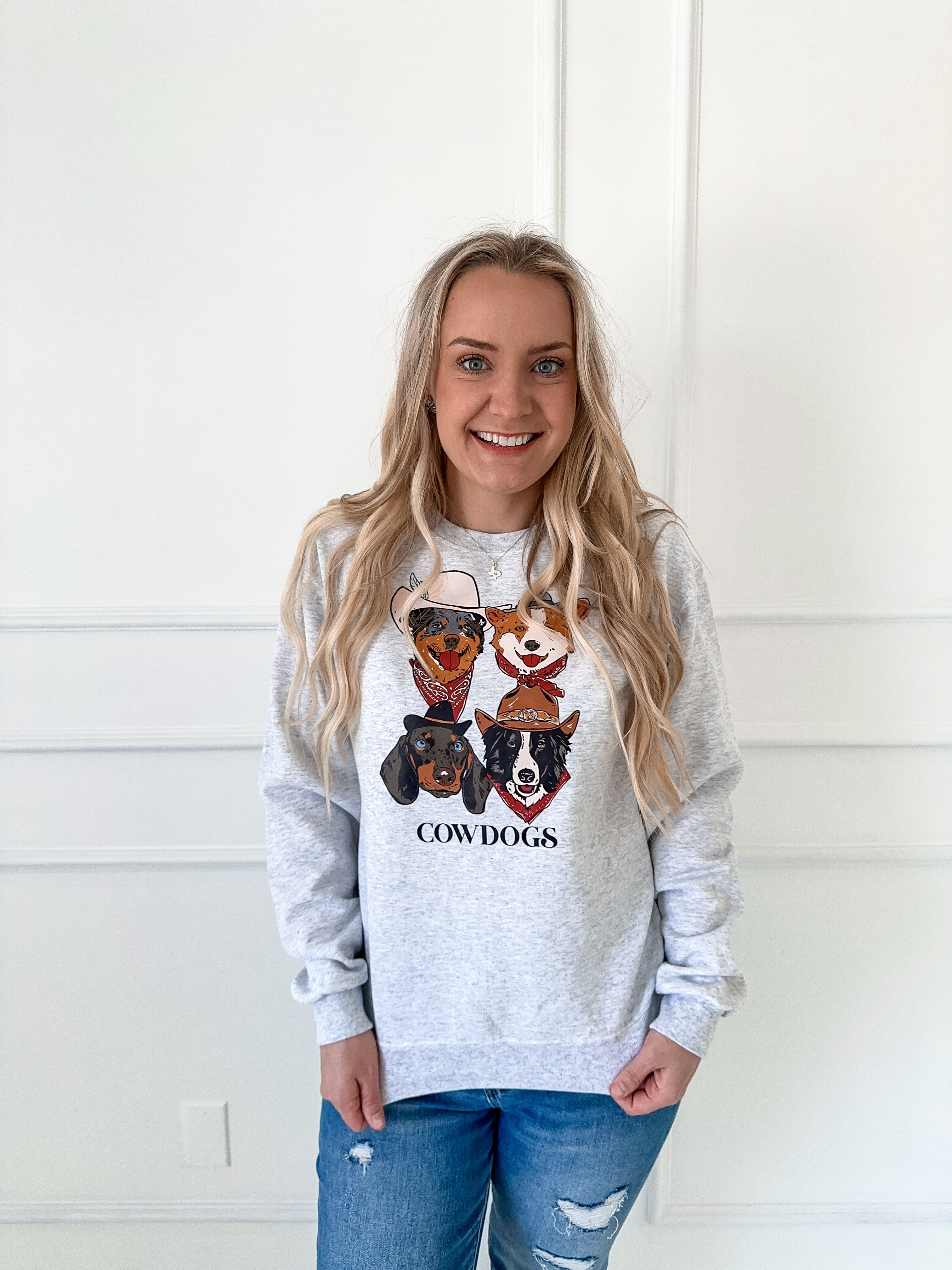Grey crewneck sweatshirt with COWDOGS text and 4 dogs dressed as cowboys