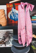 Pink Twilly scarf with horseshoe pattern.