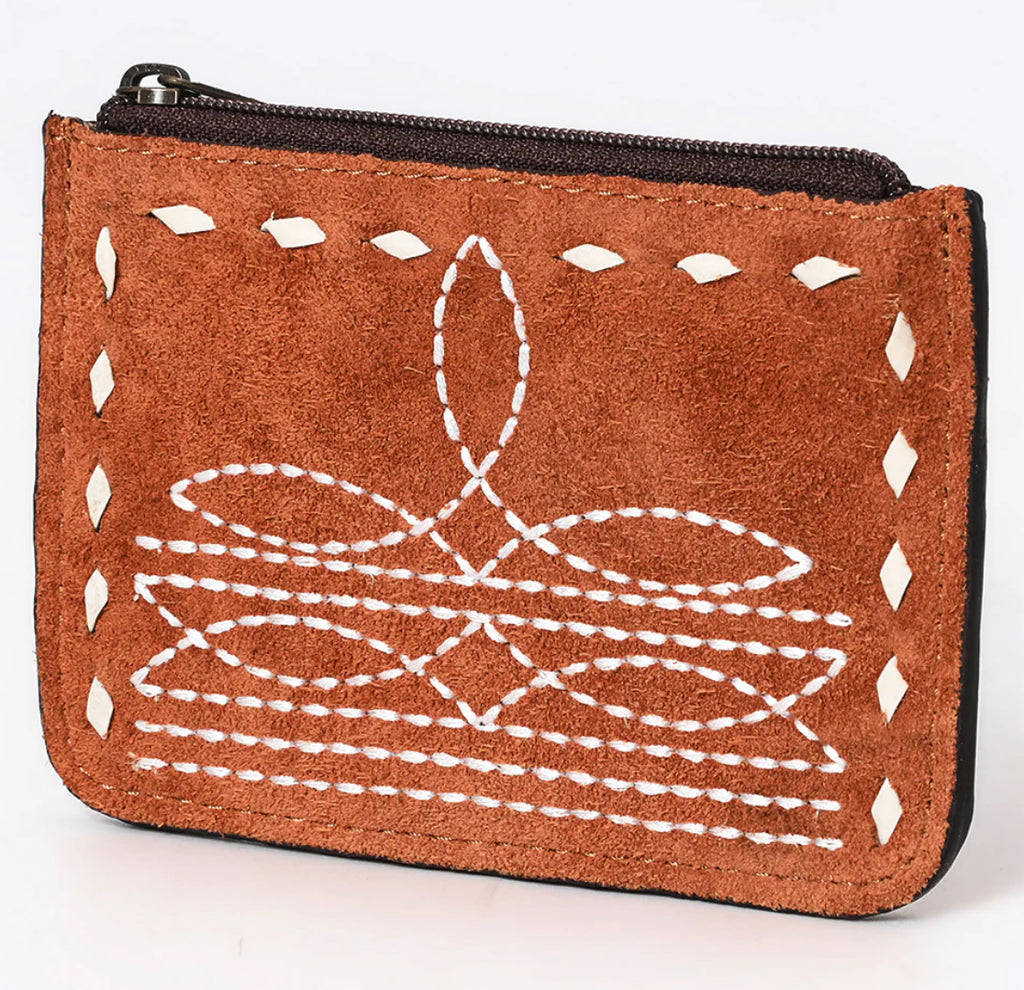 A brown suede leather card holder with hand stitched edges and a zipper closure.