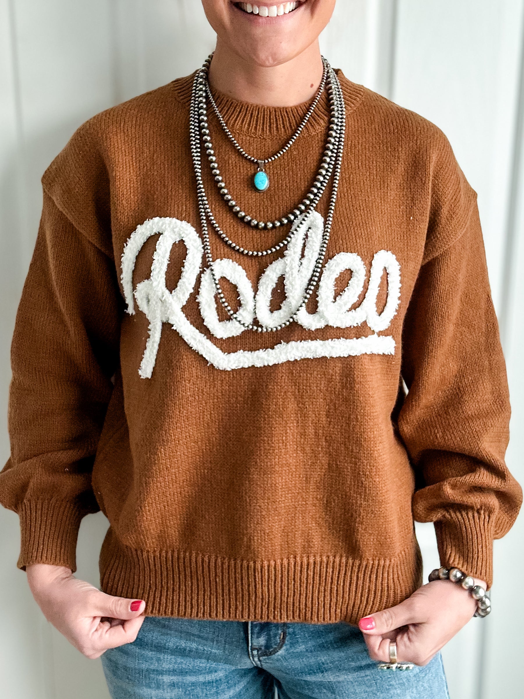 Brown sweater with Rodeo text 