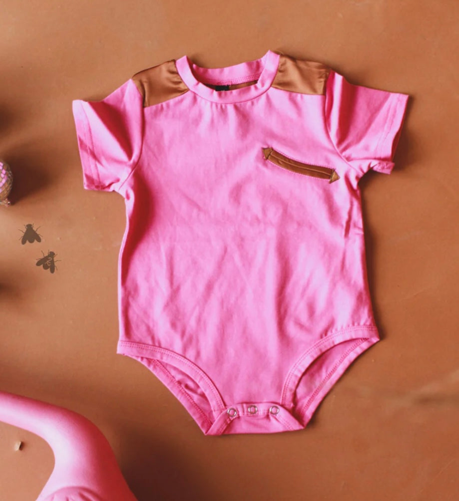 Pink baby girl onesie with arrow faux pocket design and satiny details