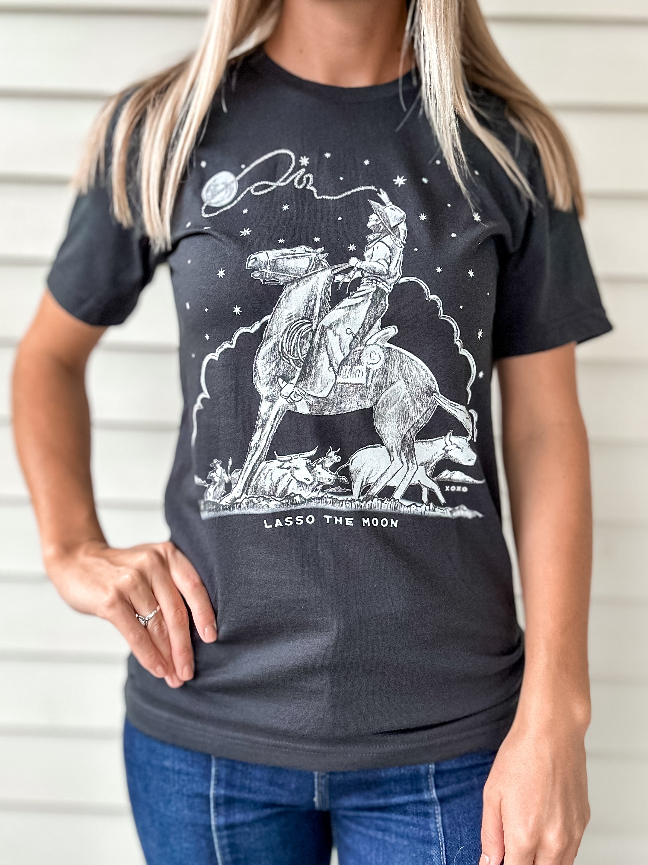 Vintage black t-shirt with a graphic design of a person lassoing the moon with rhinestones 
