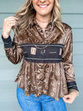 Brown and black long sleeve pearl snap blouse with bit designs.