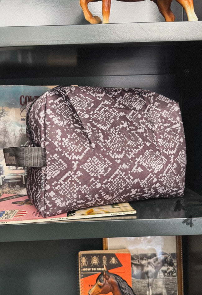 Snake print cosmetic travel pouch.