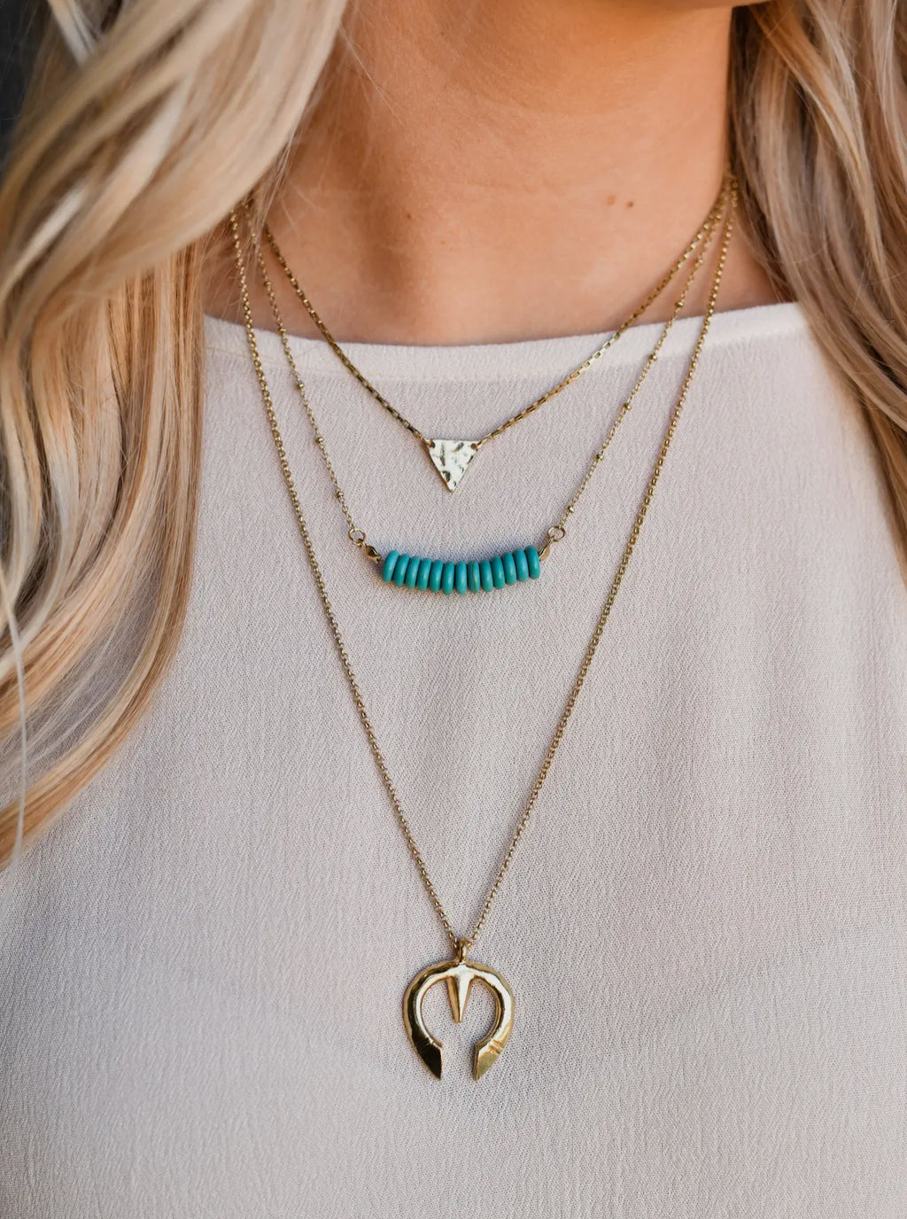 burnished gold 3 tier necklace with triangle and turquoise bead designs.
