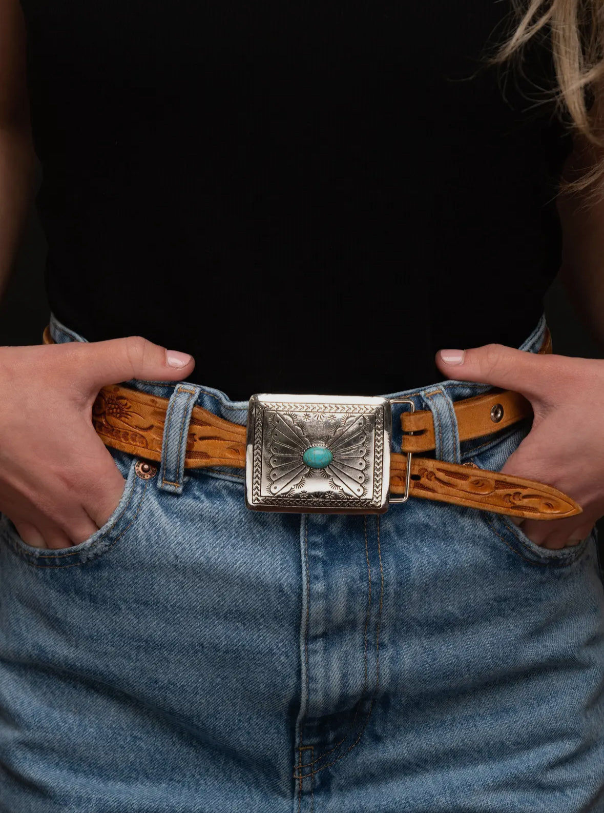 Silver rectangular belt buckle with a turquoise accent.