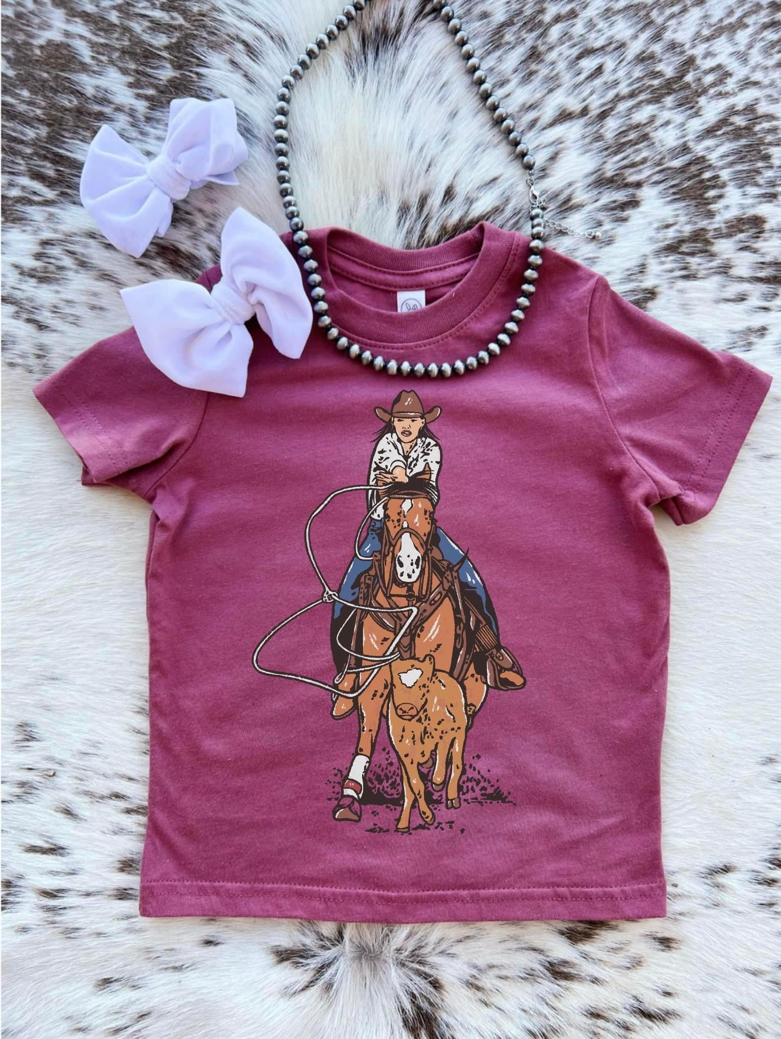 Little girls pink tee shirt with a breakaways roping design on it