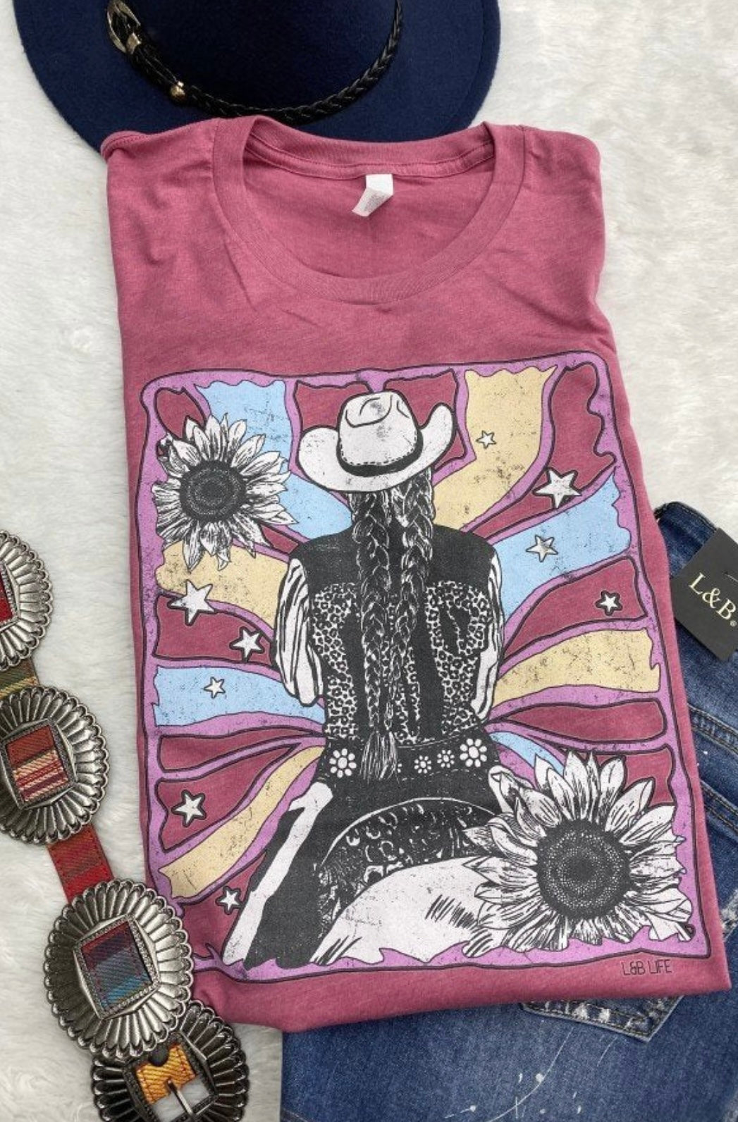 Bright pink women’s graphic tee with a cowgirl design and flowers