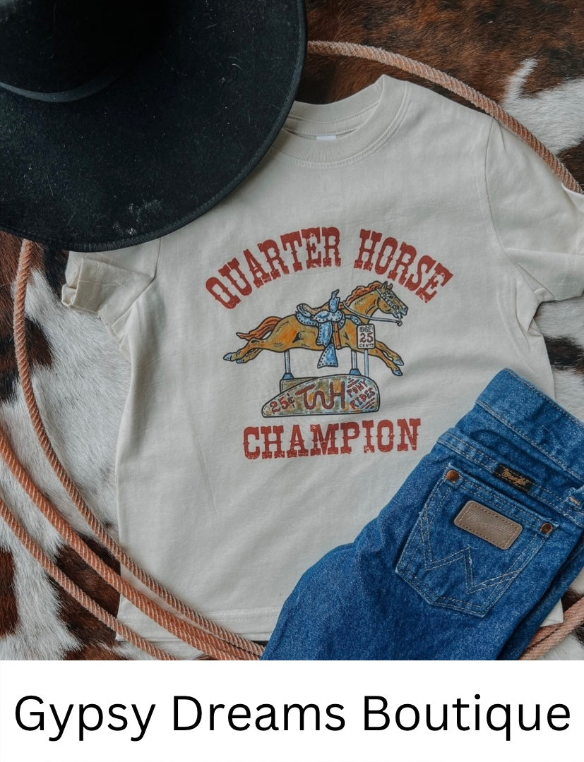 Cream colored kids tee with a toy riding horse that reads Quarter Horse Champion